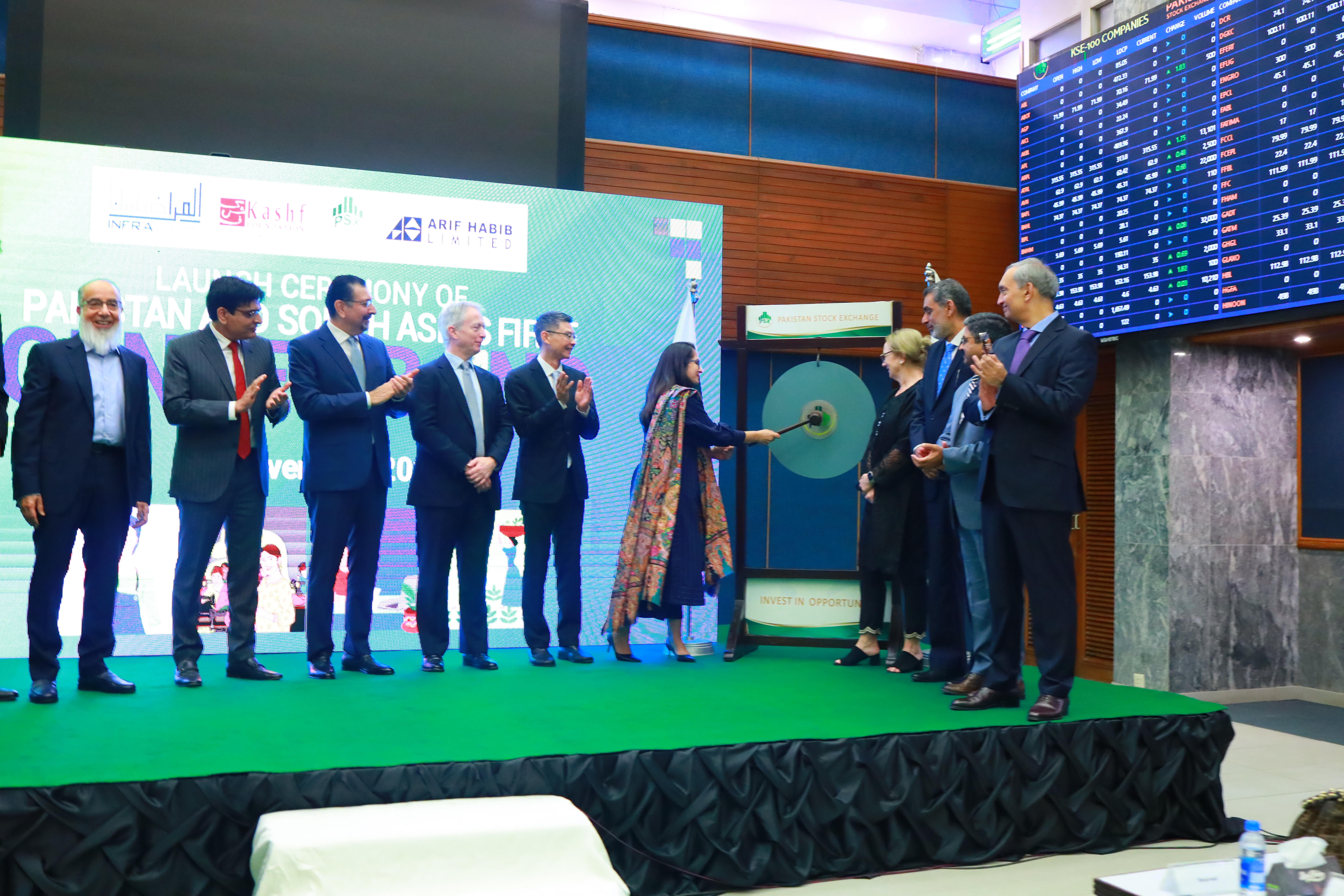 InfraZamin Pakistan CEO Maheen Rahman strikes a gong at the Pakistan Stock Exchange